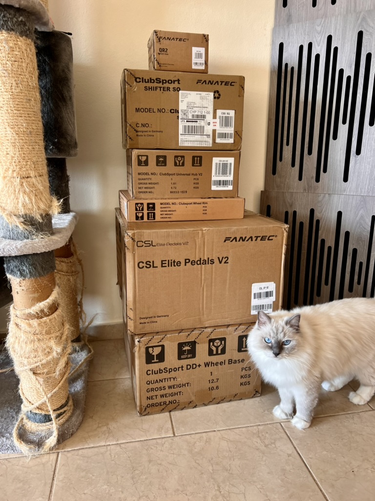 Tower of Fanatec boxes with cat